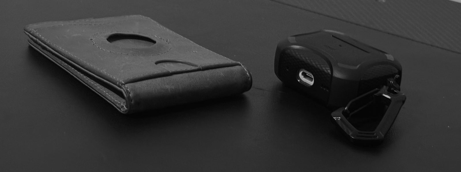 AirTag Wallet with RFID Blocking next to Apple AirPods